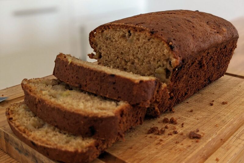 Sliced banana bread loaf on a wooden board