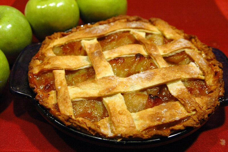 Slice of apple pie showing spiced apple filling and a flaky crust