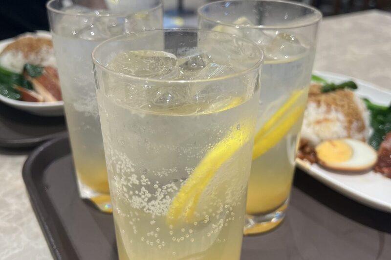 Pitcher of lemonade with lemon slices and ice